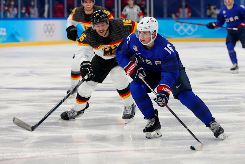 Nick Abruzzese of Team USA holds off Konrad Abeltshauser of Germany during the Olympic men's hockey tournament in Beijing last month. 