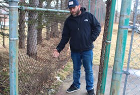 Glace Bay resident Dave Brown shows a broken portion of the gated area that surrounds the unused tennis court at Queen Elizabeth Park. "It’s only a matter of time before some kid is going to hurt themselves walking by there," he says. IAN NATHANSON/CAPE BRETON POST
