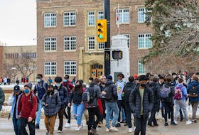  Students at Western Canada High School exit the school for their lunch break on their first day of being back in classes in the new year on Monday, January 10, 2022.