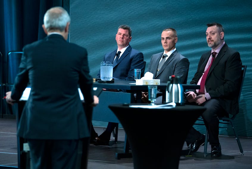 RCMP Constables Adam Merchant, Aaron Patton and  Stuart Beselt, left to right, the first officers on the scene in Portapique,  are questioned by commission counsel Roger Burrill at the Mass Casualty Commission inquiry into the mass murders in rural Nova Scotia on April 18/19, 2020, in Halifax on Monday, March 28, 2022. THE CANADIAN PRESS/Andrew Vaughan