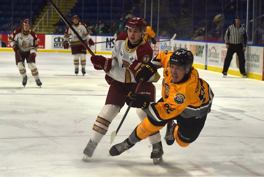 Nicholas Girouard of the Cape Breton Eagles, right, falls after taking a shot while Riley Kidney of the Acadie-Bathurst Titan chases during Quebec Major Junior Hockey League action at Centre 200 earlier this month. Girouard is in his final season of major junior hockey. JEREMY FRASER/CAPE BRETON POST