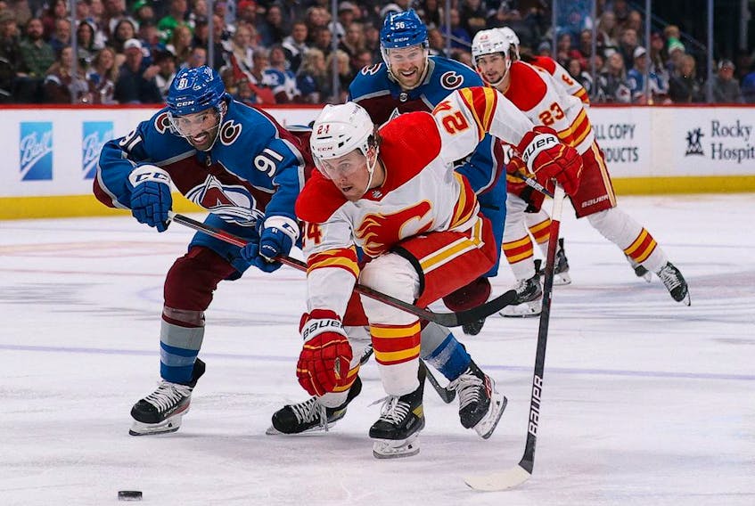 Calgary Flames forward Brett Ritchie skates for the puck against Colorado Avalanche forward Nazem Kadri at Ball Arena in Denver on March 13, 2022. 