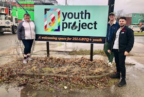 From left, Madonna Doucette, Mitch Hill and Bradley Murphy from the Cape Breton Youth Project stand near the sign outside their soon to be new office space on Townsend Street in December, 2021, just after they got the two-floor location. NICOLE SULLIVAN/CAPE BRETON POST 