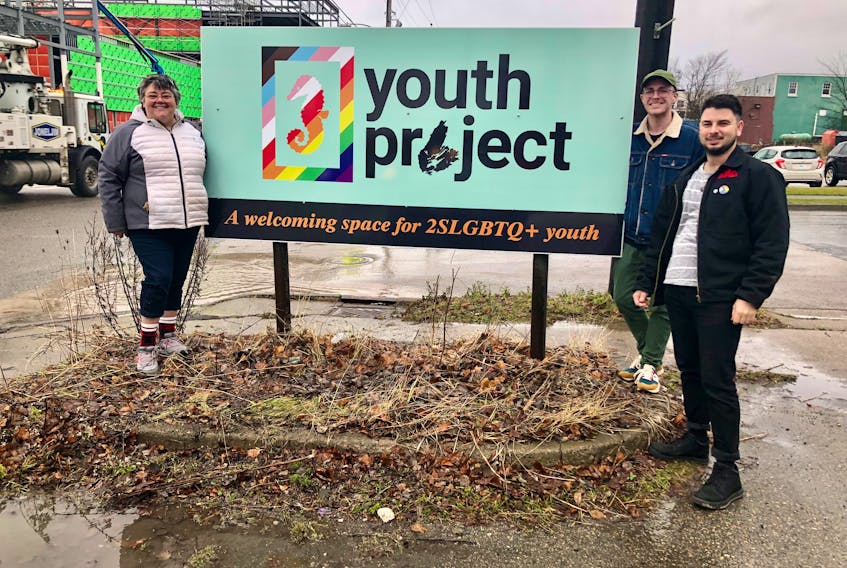 From left, Madonna Doucette, Mitch Hill and Bradley Murphy from the Cape Breton Youth Project stand near the sign outside their soon to be new office space on Townsend Street in December, 2021, just after they got the two-floor location. NICOLE SULLIVAN/CAPE BRETON POST 