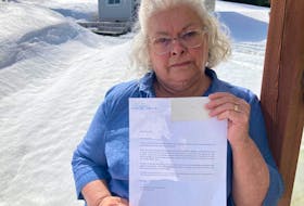 Country Road resident Cathy Peddle, spokesperson for the Concerned Citizens Against Crematorium in Our Neighbourhood, Corner Brook group is disgusted with a letter she and 10 other residents on the Corner Brook street received ordering them to remove signs from their properties. The signs are being used to protest the building of a crematorium in the neighbourhood.