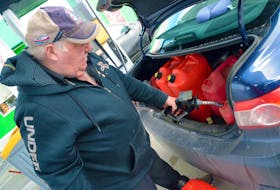 Ed McEvoy fills gas containers while fuelling his vehicle in Holyrood Thursday afternoon, March 3. Gasoline prices at the pumps went up 14.4 cents per litre today, a jump Finance Minister Siobhan Coady attributes to the war in Ukraine. KEITH GOSSE/SALTWIRE NETWORK