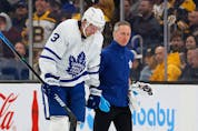 Maple Leafs’ Justin Holl is led off the ice by a trainer after being cut during the second period against the Boston Bruins at TD Garden. WINSLOW TOWNSON/USA TODAY SPORTS