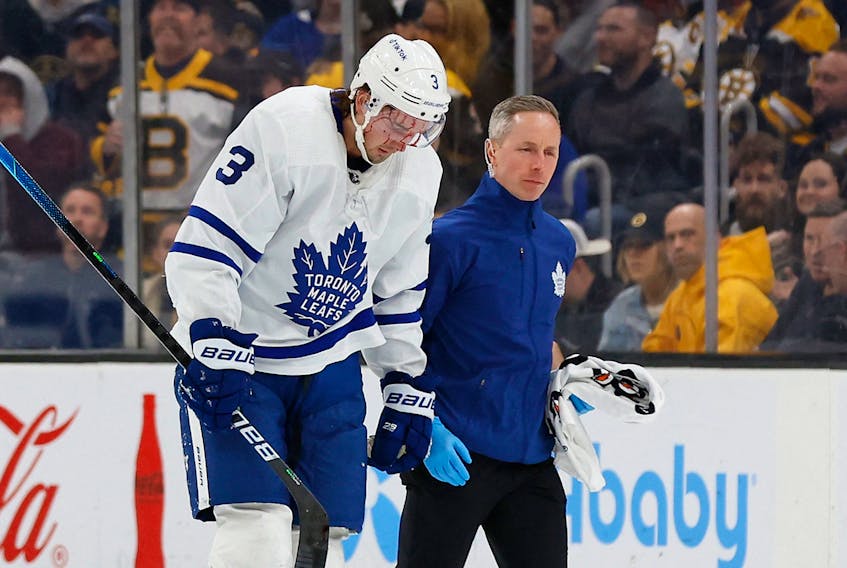  Maple Leafs’ Justin Holl is led off the ice by a trainer after being cut during the second period against the Boston Bruins at TD Garden. WINSLOW TOWNSON/USA TODAY SPORTS