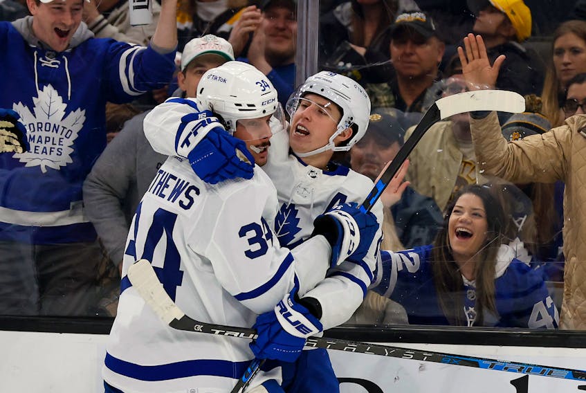 Maple Leafs' Auston Matthews (left) congratulates teammate Mitch Marner after Marner scored against the Bruins during the second period at TD Garden in Boston on Tuesday, March 29, 2022.