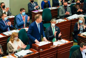 Finance and Treasury Board Minister Allan MacMaster tables the budget with masked members of the Legislature on Tuesday, March 29, 2022. Credit Communications Nova Scotia