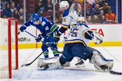 St. Louis Blues defenceman Marco Scandella (6) looks on as goalie Ville Husso (35) makes a save on a shot by Vancouver Canucks forward Elias Pettersson (40) in the first period at Rogers Arena.