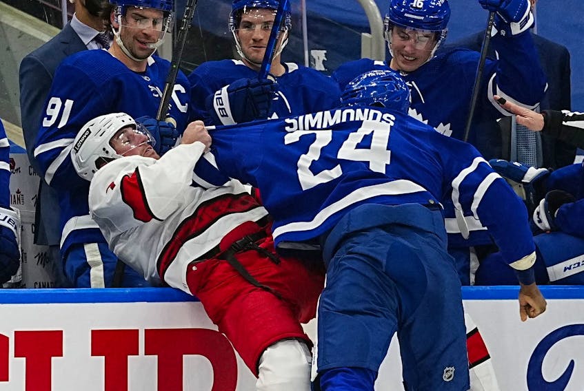 Feb 7, 2022; Toronto, Ontario, CAN; Toronto Maple Leafs forward Wayne Simmonds (24) fights with Carolina Hurricanes defenceman Brendan Smith (7) during the first period at Scotiabank Arena. 