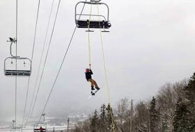 A skier is lowered from a chairlift at Marble Mountain Saturday after the lift broke down. Facebook-Gary Chaulk