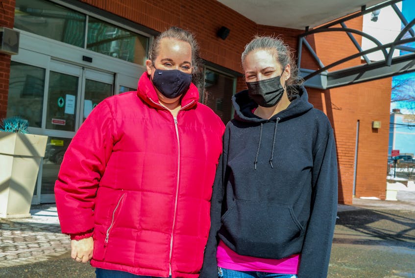 Reena MacIntosh, left, and Jessica Binder, right, stand in front of the Holiday Inn hotel in Sydney, where they are staying until at least Monday. They say all the tenants in their apartment building in New Waterford were ordered to leave on Friday afternoon without advance warning. JESSICA SMITH/CAPE BRETON POST