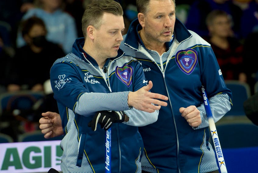 Nova Scotia third Scott Saccary, left, and skip Paul Flemming discuss strategy during their opening game against Jamie Koe of the Northwest Territories on Saturday at the Tim Hortons Brier in Lethbridge, Alta. Michael Burns/Curling Canada