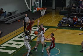 The UPEI Panthers’ Sam Chisholm hauls in a defensive rebound in the second half of an Atlantic University Sport men’s basketball game against the Acadia Axemen at the Chi-Wan Young Sports Centre in Charlottetown on March 5. UPEI’s Isaiah Ankra, left, supports Chisholm, who is defended by Axemen Jack Tilley, 8, and Ryan Munro as Acadia's Adam Barney, 12, follows the play. UPEI won the game 76-71.