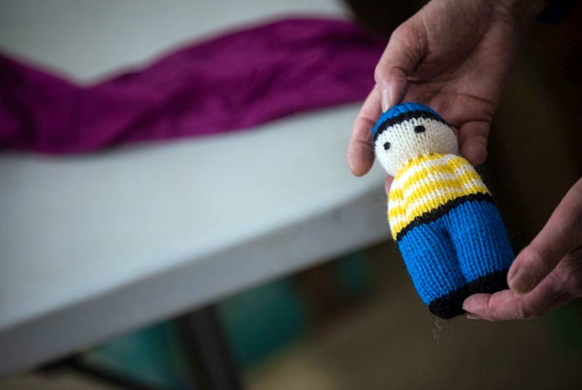  Multiple large bags of small, hand-knit dolls like this one were also donated Saturday.