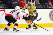  Evgenii Dadonov (63) of the Vegas Golden Knights skates with the puck against Erik Brannstrom (26) of the Ottawa Senators in the second period of their game at T-Mobile Arena on March 6, 2022 in Las Vegas, Nevada.