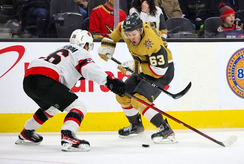  Evgenii Dadonov (63) of the Vegas Golden Knights skates with the puck against Erik Brannstrom (26) of the Ottawa Senators in the second period of their game at T-Mobile Arena on March 6, 2022 in Las Vegas, Nevada.