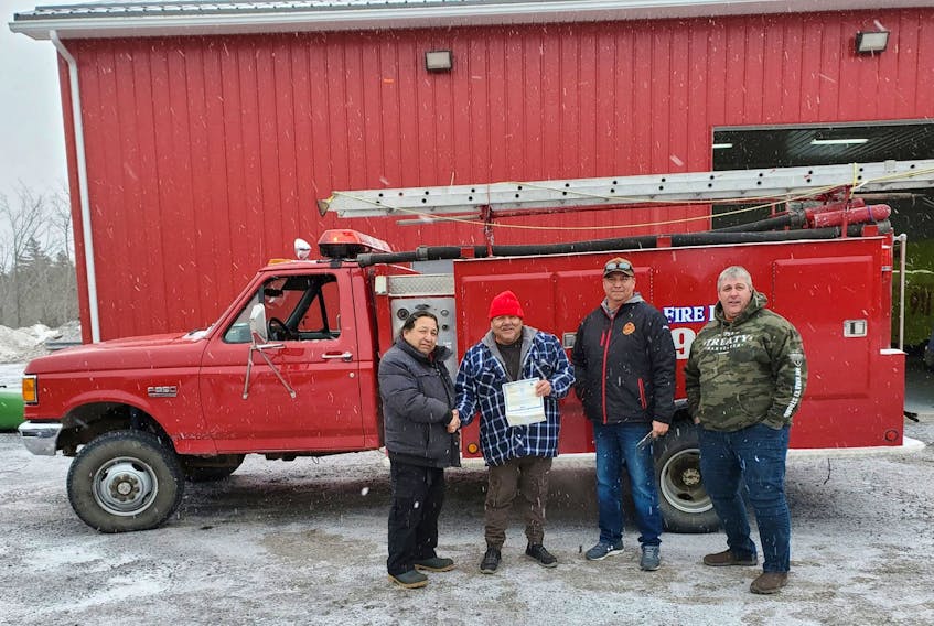 John Cremo, Leonard Cremo, Junior Gould and Dennis Worthen with the donated mini-pumper. 