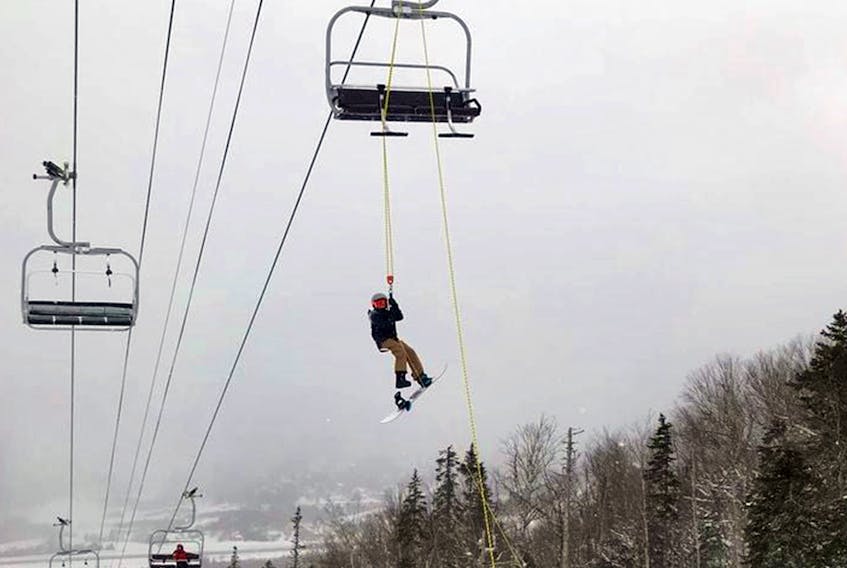 A skier is lowered from a chairlift at Marble Mountain Saturday, March 5, after the lift broke down. — Facebook/Gary Chaulk