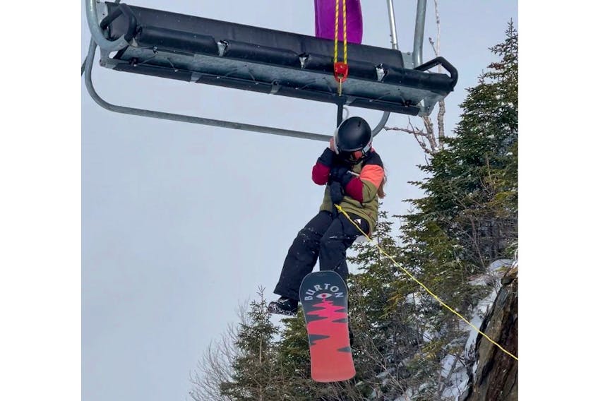 Nine-year-old Sadie Osmond being rappelled down from the chairlift at Marble Mountain. Sadie was on the lift for several hours. When hand warmers were thrown up to her, she took off her gloves to use them, but her hands were so cold, she couldn't put her gloves back on.