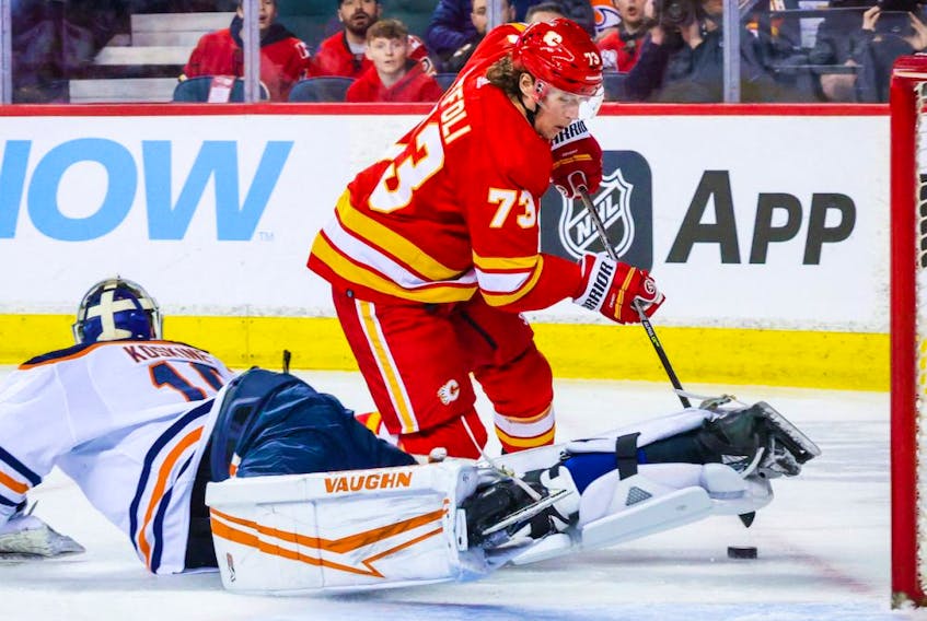 Edmonton Oilers goaltender Mikko Koskinen (19) makes a save against Calgary Flames right wing Tyler Toffoli (73) during the first period at Scotiabank Saddledome on March 7, 2022. 