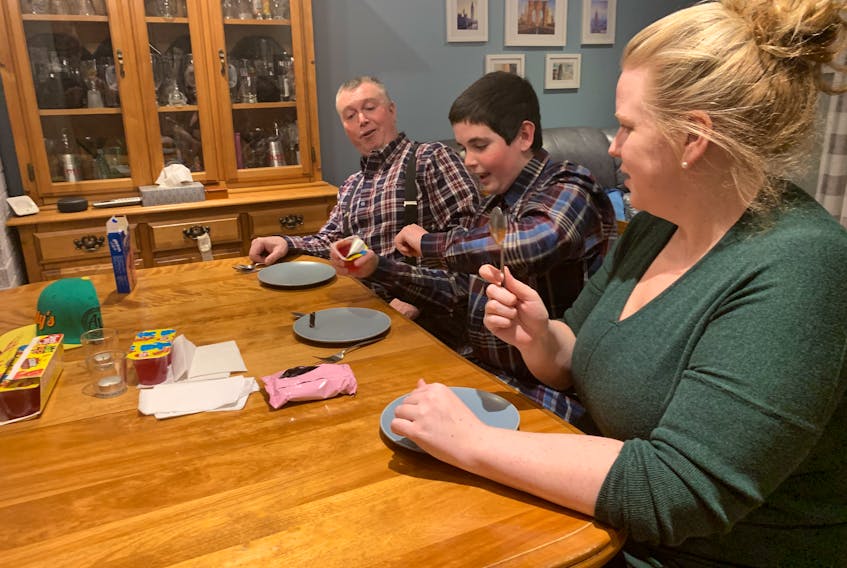 David Gogan (left) and Pam Chappell look on as Landen Gogan, host of the Landenator Show, opens a Jell-O treat during one of his online shows. The Amherst 13-year-old has a weekly show on Facebook and YouTube that has several hundred followers. Darrell Cole – SaltWire Network

