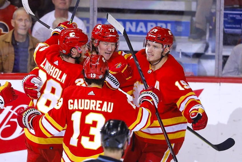 Calgary Flames forward Tyler Toffoli (centre, back) celebrates with Elias Lindholm, Johnny Gaudreau and Matthew Tkachuk after scoring against the Edmonton Oilers at Scotiabank Saddledome in Calgary on Monday, March 7, 2022.