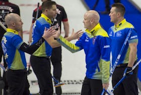 Team Alberta,(from left) second BJ Neufeld, third John Morris, skip Kevin Koe and lead Ben Hebert shake hands after defeating Ontario in a Tim Hortons Brier preliminary round game on March 6, 2022 in Lethbridge.