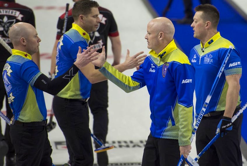 Team Alberta,(from left) second BJ Neufeld, third John Morris, skip Kevin Koe and lead Ben Hebert shake hands after defeating Ontario in a Tim Hortons Brier preliminary round game on March 6, 2022 in Lethbridge.