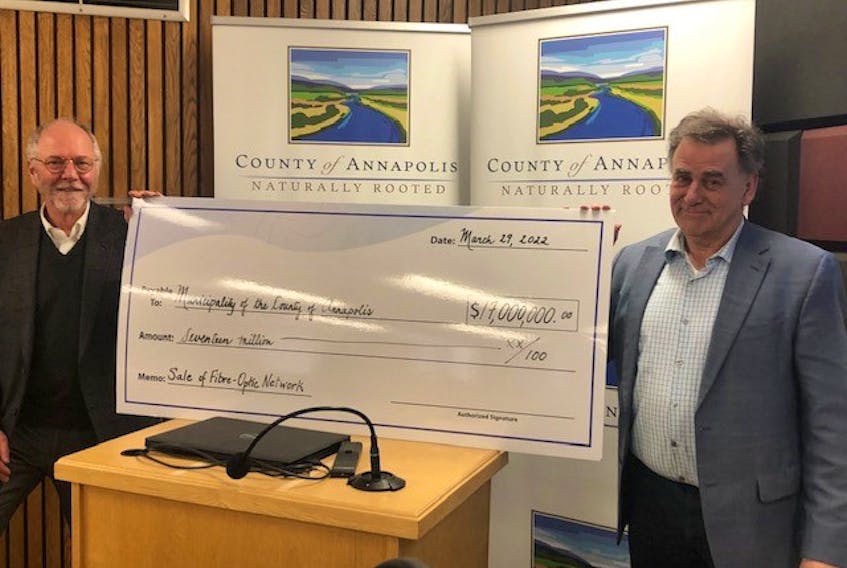 Annapolis County Warden Alan Parish, left, and CAO David Dick with a $17-million cheque after council approved a motion to sell its fibre optic network to Xplornet Communications Inc. on March 29.