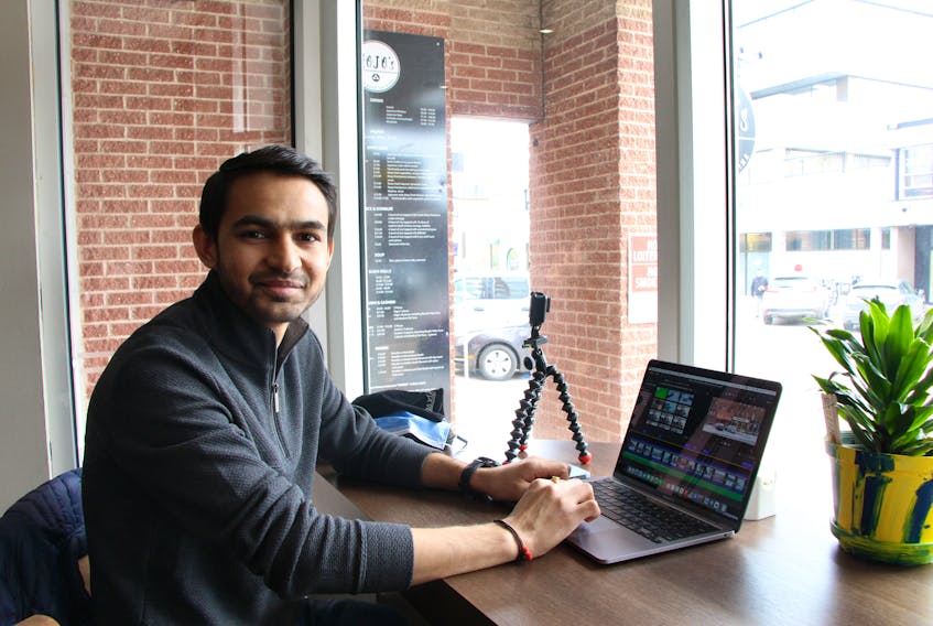 Apurva Patel edits a video for his YouTube channel at Alambé Coffee in Charlottetown. Patel doesn’t use an expensive camera, just his iPhone and Go-Pro. 
