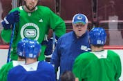  ‘He keeps giving us positive energy, to go out there and not hang our heads-type stuff,’ Canucks winger Tanner Pearson (left) says of head coach Bruce Boudreau (right).