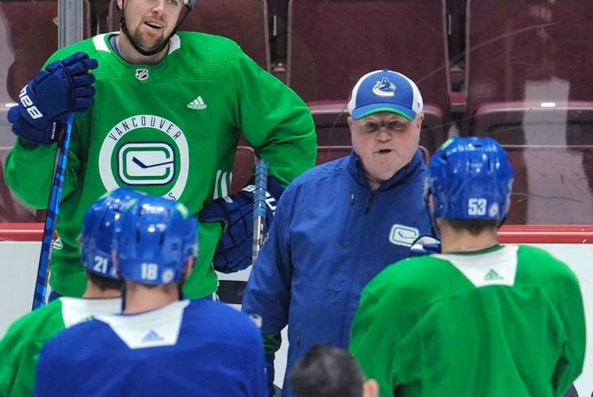  ‘He keeps giving us positive energy, to go out there and not hang our heads-type stuff,’ Canucks winger Tanner Pearson (left) says of head coach Bruce Boudreau (right).