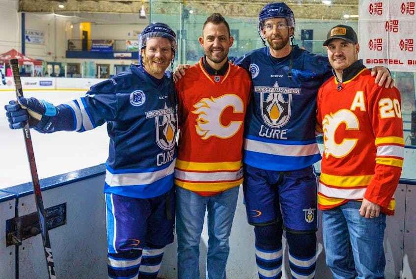 Steve Lilly, Cory Sarich, David Babin and Curtis Glencross pose for a portrait at the recreation centre rink in Chestermere on Tuesday, April 5, 2022. Sarich and Glencross came to support the hockey marathon. 