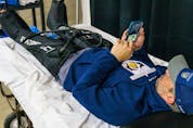  Shawn Merkley relaxes while using a leg compression machine at the recreation centre rink in Chestermere on Tuesday, April 5, 2022. The machine is used to help prevent blood clots in the deep veins of the legs.