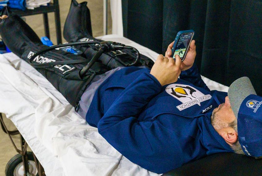  Shawn Merkley relaxes while using a leg compression machine at the recreation centre rink in Chestermere on Tuesday, April 5, 2022. The machine is used to help prevent blood clots in the deep veins of the legs.
