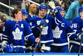 Maple Leafs forward Auston Matthews (middle) acknowledges a tribute by fans after setting a new Maple Leafs single season record for goals during a break in the action against the Montreal Canadiens at Scotiabank Arena on Saturday night.