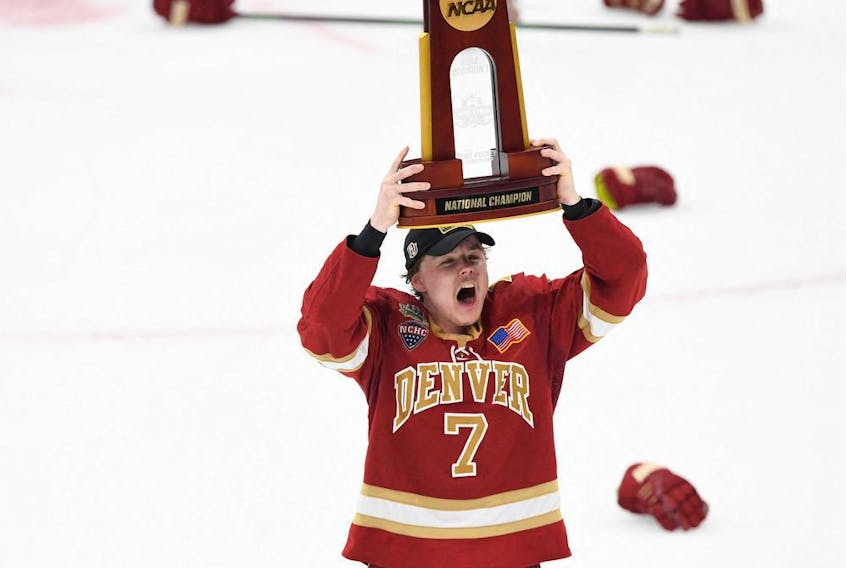 Denver Pioneers forward Brett Stapley (7) celebrates the trophy after the Pioneers defeated the Minnesota State Mavericks in 2022 Frozen Four college ice hockey national championship game at TD Garden.