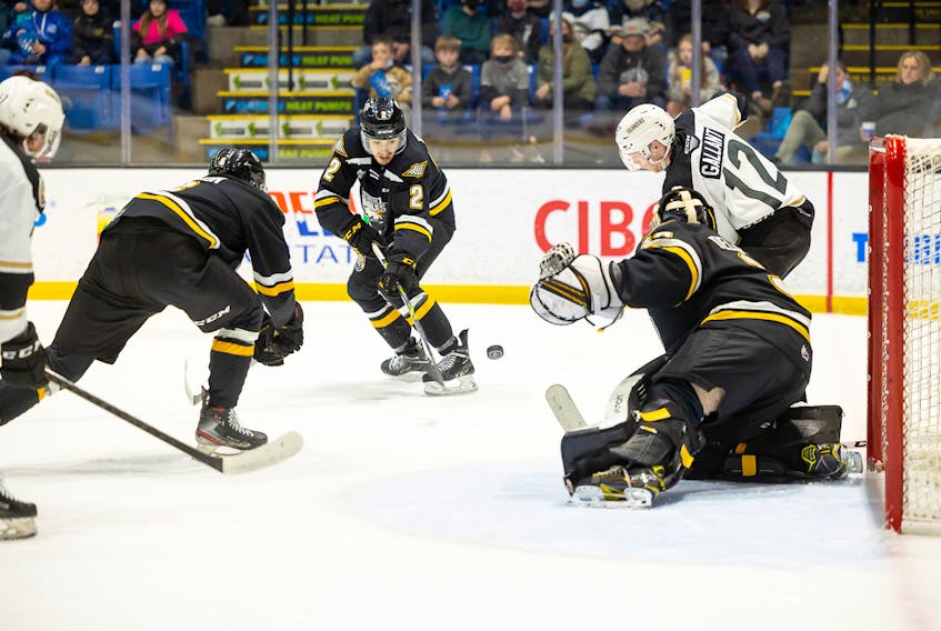 Charlottetown Islanders forward Keiran Gallant, 12, and Cape Breton Eagles defenceman Francois-James Buteau, 2, focus on the puck in front of Cape Breton Eagles goaltender Rémi Delafontaine. The action took place during a Quebec Major Junior Hockey League game in Charlottetown on April 9. The Islanders won the contest 4-2. Darrell Theriault Photo/Courtesy of Charlottetown Islanders