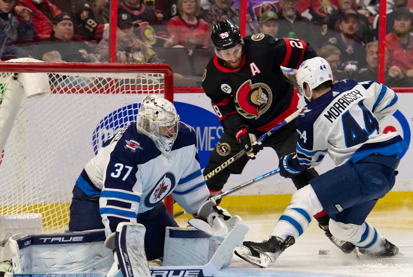 Winnipeg Jets defenceman Josh Morrissey (44) battles with Ottawa Senators right wing Connor Brown (28) in the second period at the Canadian Tire Centre. 