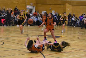 Jenna Adams (on the floor) has the presence of mind to find teammate Jewel Woolfit after breaking up a Horton Griffins pass and outhustling her opponent to the ball. The play, in the final minute of the provincial final, essentially locked up the Cougars’ victory