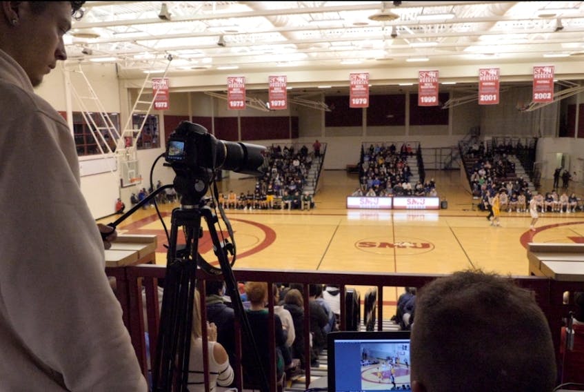 A videographer from Maritime Athletic PROfiles records the Capital Region boys championship basketball game at Saint Marys University in Halifax.
