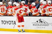  Calgary Flames forward Trevor Lewis celebrates with the bench after scoring a goal against the Seattle Kraken at Climate Pledge Arena in Seattle on Saturday, April 9, 2022.
