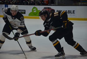 Cape Breton Eagles defenceman Jacob Squires, 15, and Charlottetown Islanders forward Dawson Stairs, 25, follow the play during a Quebec Major Junior Hockey League game at Eastlink Centre on April 10. The Islanders defeated the Eagles 2-1 to sweep a two-game weekend series.