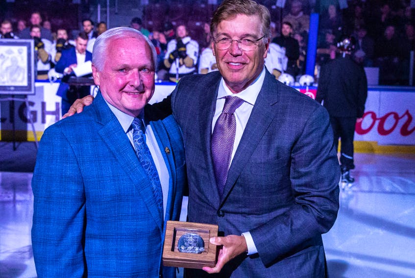 Newfoundland Growlers President Glenn Stanford (left) was honoured for his contributions to professional hockey in Newfoundland and Labrador during a ceremony at the Mary Brown's Centre on April 10. Stanford is being presented with a commemorative puck from Growlers owner Dean MacDonald.