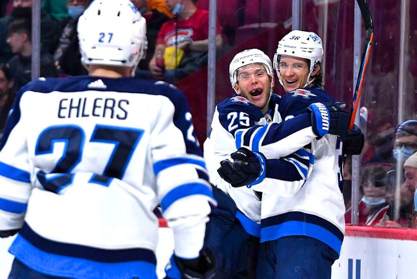 Halifax's Morgan Barron, right, celebrates his goal with Winnipeg Jets linemates Paul Stastny and Nikolaj Ehlers during an NHL game in Montreal against the Canadiens on Monday. - NHL