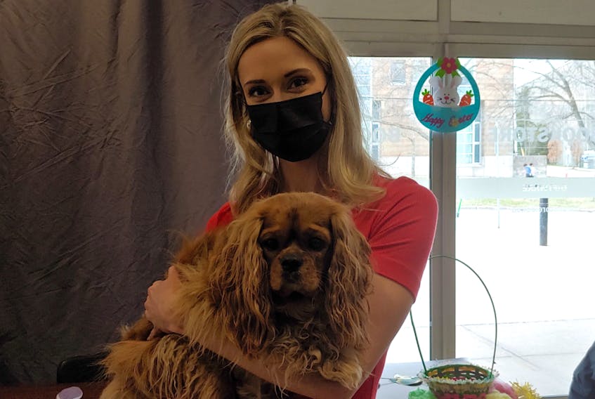 Miss Universe Canada delegate Sophie Church poses for a photo with dog-therapist Henry during the Dog Therapy for Ukraine event.