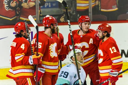 The Calgary Flames celebrate a goal against the Seattle Kraken at the Scotiabank Saddledome on Tuesday, April 12, 2022. 